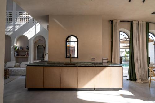 a kitchen with a large island in a living room at Villa Riad- וילה ריאד מתחם נופש יוקרתי in Migdal
