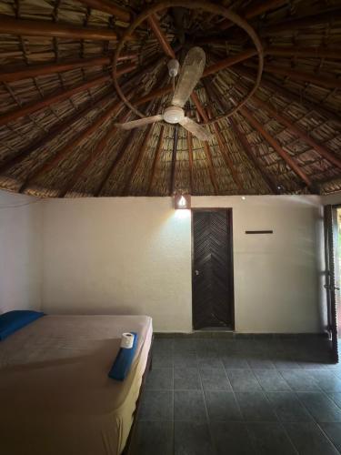 a bedroom with a ceiling with a ceiling fan at Shalom Backpacker Hostel in Puerto Escondido