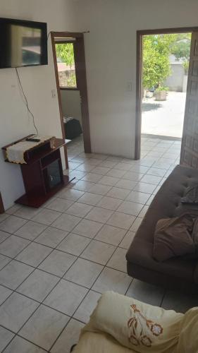 a living room with a couch and a piano at José Nilton in Imbituba