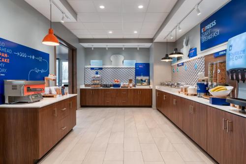 a large kitchen with wooden cabinets and counters at Holiday Inn Express & Suites Westfield - Indianapolis by IHG in Westfield