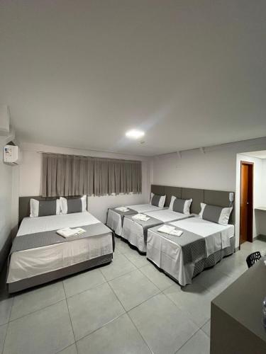 a bedroom with two beds in a room at Mimari Hotel in Tangara da Serra