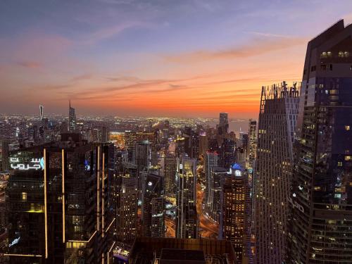 a view of a city skyline at sunset at 77 Floor Luxury 1Br Marina Sea View Balcony in Dubai