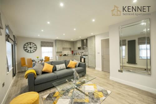 a living room with a couch and a table at Chester House in Reading