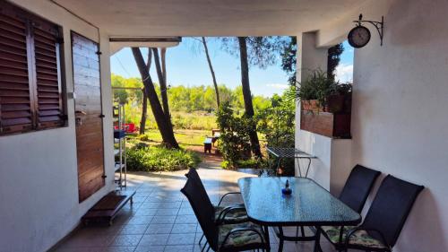 a table and chairs on a patio with a view at Apartments Vera - Mirca in Mirce