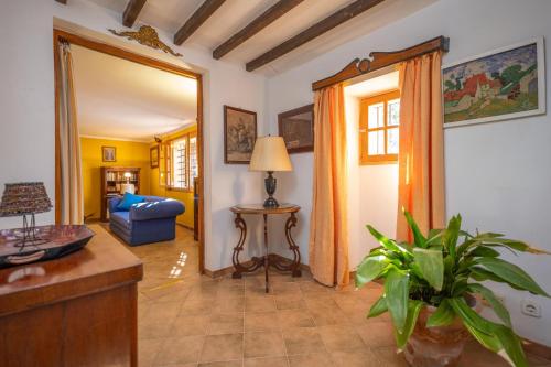 a living room with a blue couch and a table at Ca Na Carme (Alaronera) in Alaró