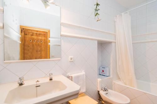 a white bathroom with a sink and a mirror at Ca Na Carme (Alaronera) in Alaró