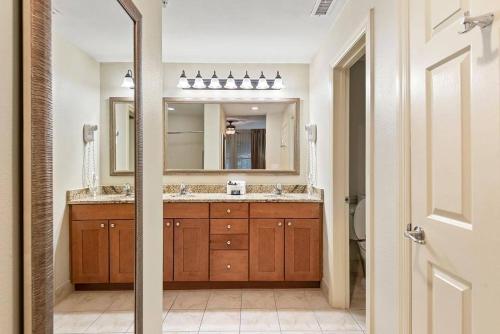 a bathroom with two sinks and a large mirror at Royal Dunes in Hilton Head Island