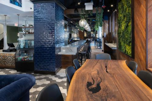 a restaurant with a wooden table and chairs at Hotel Saint Clair - Magnificent Mile in Chicago
