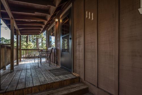 a front porch of a house with a glass door at RockInn Pines in Ruidoso