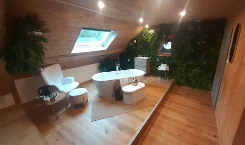 an overhead view of a bathroom with a tub and a sink at Chambre d'hôte de la Source Bleue in Cusance