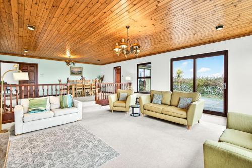 a living room with couches and a wooden ceiling at Mullaghmore Holiday Home in Cliffony