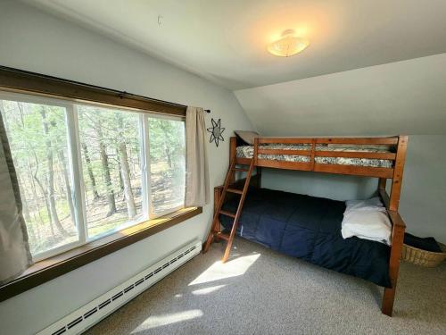 a bedroom with a bunk bed and a window at Morel Mountain Hideaway in Warren