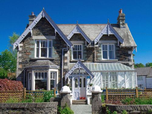 a large brick house with white doors and windows at Elim Bank Guest House in Windermere