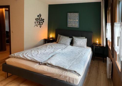 a bedroom with a large bed with two night stands at Chalet Oasis - Your Alpine Hideaway in Bürglen
