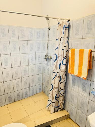 a bathroom with a shower with a shower curtain at Moragalla Relax Stay in Beruwala