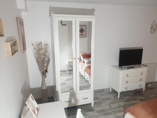 a room with a mirror and a dresser with a television at La Terracotta Rer C -N104-A6 in Brétigny-sur-Orge