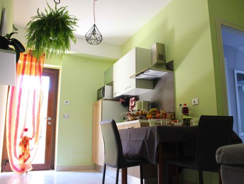 a kitchen with a table and a refrigerator at Il Roseto di Daniela in Montefiascone