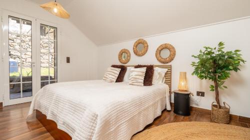 a bedroom with a large bed with mirrors on the wall at Stonewood Valley by LovelyStay in Curral das Freiras