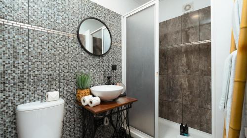a bathroom with a sink and a mirror at Stonewood Valley by LovelyStay in Curral das Freiras