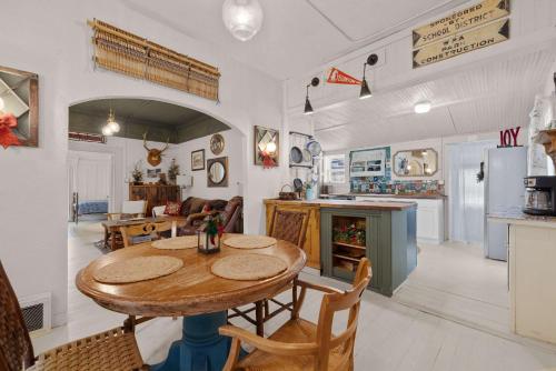 a kitchen and living room with a table and chairs at Camp Red Lodge - Cozy & Convenient in Red Lodge