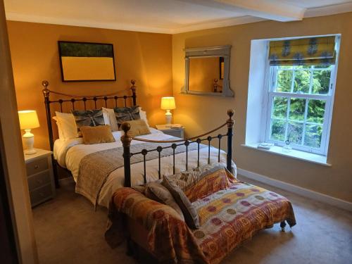 a bedroom with a large bed and a window at Gospatric House in Ripon