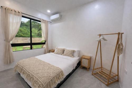 a bedroom with a bed and a window at Lunara Villas in El Nido