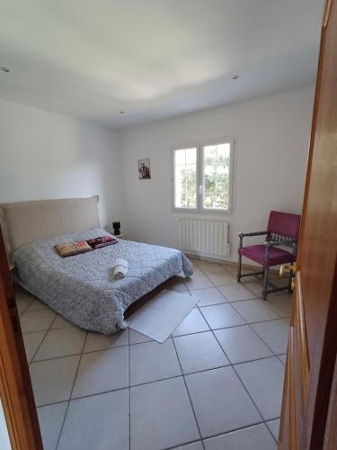 a bedroom with a bed and a chair in it at La ferme in Moltifao