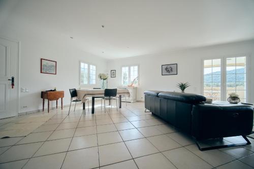a living room with a couch and a table at La ferme in Moltifao