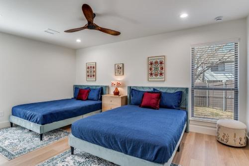 a bedroom with two beds and a ceiling fan at La Fleur Chateau 4B 2B Duplex KING Pet Friendly in Richardson
