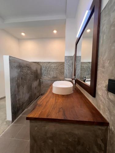 a bathroom with a sink and a mirror at The Ellen Horizon in Baddegama