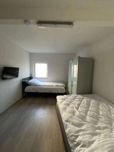 a room with two beds and a window at Ferienwohnung Fatlume No 7 in Bad Honnef am Rhein