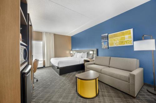 a hotel room with a bed and a couch and a bedroom at Comfort Inn Chattanooga Downtown Southside in Chattanooga