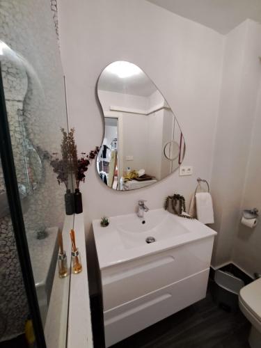 a bathroom with a white sink and a mirror at Aguadulce Beach in Aguadulce