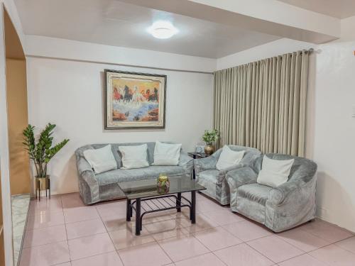 a living room with two couches and a coffee table at La-Rivière Vacation Home in Lal-lo