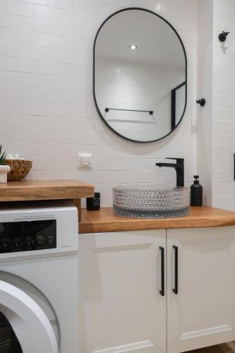 a bathroom with a sink and a mirror on the wall at Maelia Samos Apartment in Ríva