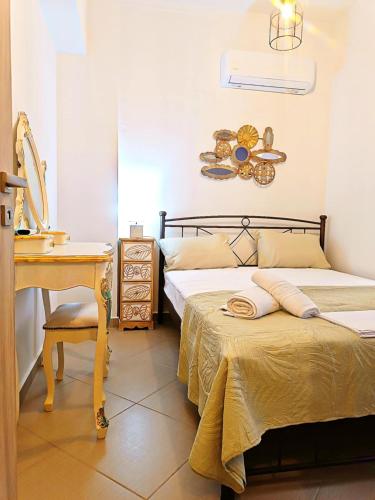 a bedroom with two beds next to a desk and a table at Argento in Vrontádos