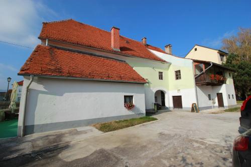 a large white house with a red roof at Guesthouse Veles in Slovenska Bistrica