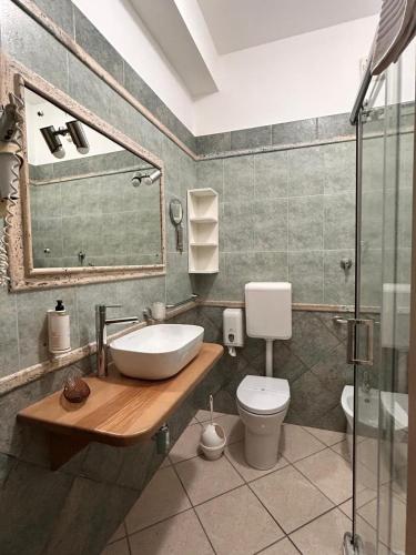a bathroom with a sink and a toilet at Hotel Al Faro in Licata