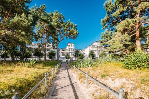 a path in front of a large white building at Hotel Villa Belvedere in Binz