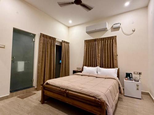 a bedroom with a bed and a ceiling fan at Sree Devi Grande in Chennai