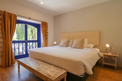 a bedroom with a large bed and a window at Muru Suites near Plaza de Armas Cusco by Wynwood House in Cusco