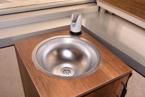 a bathroom sink with a soap dispenser on it at Asrin Business Hotel Kızılay in Ankara