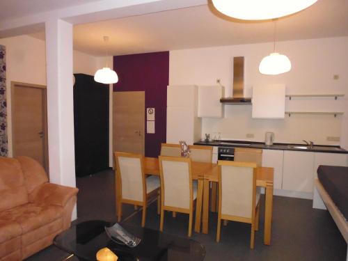 a kitchen and dining room with a table and chairs at B&B V.K. PGmbH in Saint-Vith