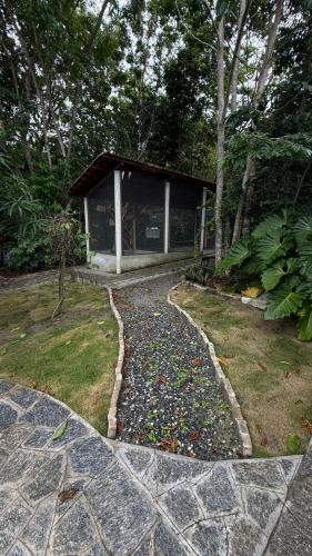 a stone walkway leading to a building in a garden at Apartamento Zion reserve suites in Conde