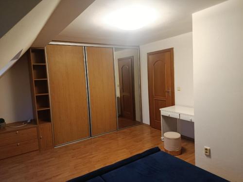 an empty room with wooden cabinets and a kitchen at Central apartment in Staré Mesto