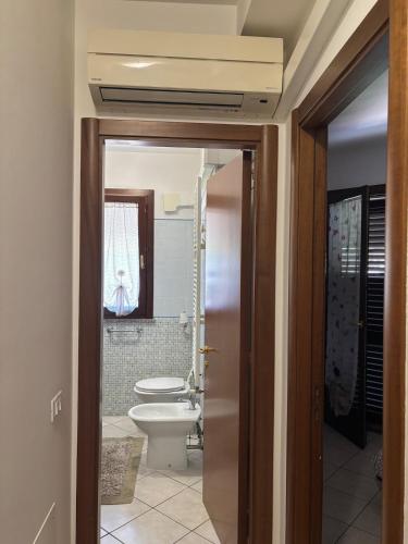 a bathroom with a toilet and a sink at Home 14 in Tortoreto Lido
