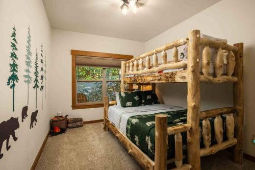 a bedroom with a wooden bunk bed in a room at Moose Meadow in Welches
