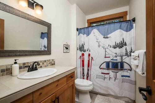 a bathroom with a sink and a shower curtain at Moose Meadow in Welches