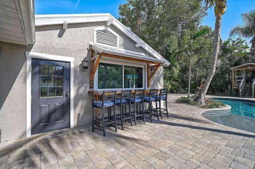 a group of stools sitting in front of a house at Villa Manteago in Bradenton