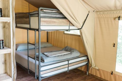 a bunk bed in a tent at GlampKnox Canvas Campground - Grande in Knoxville